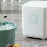 Countertop ice maker producing ice cubes for chilled drinks