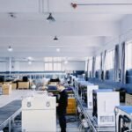 A technician testing commercial ice machines on the KAISON production floor